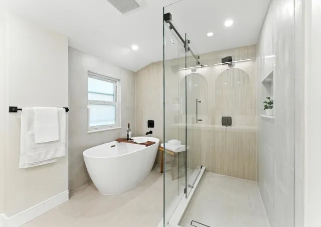 a spacious bathroom with a bathtub and shower