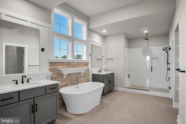 a bathroom with a tub sink and mirror