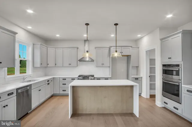 a kitchen that has a lot of cabinets in it and appliances