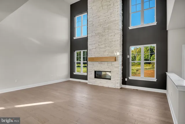 a view of a livingroom with a fireplace and window