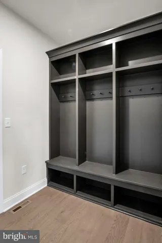 a view of an empty room with closet and windows