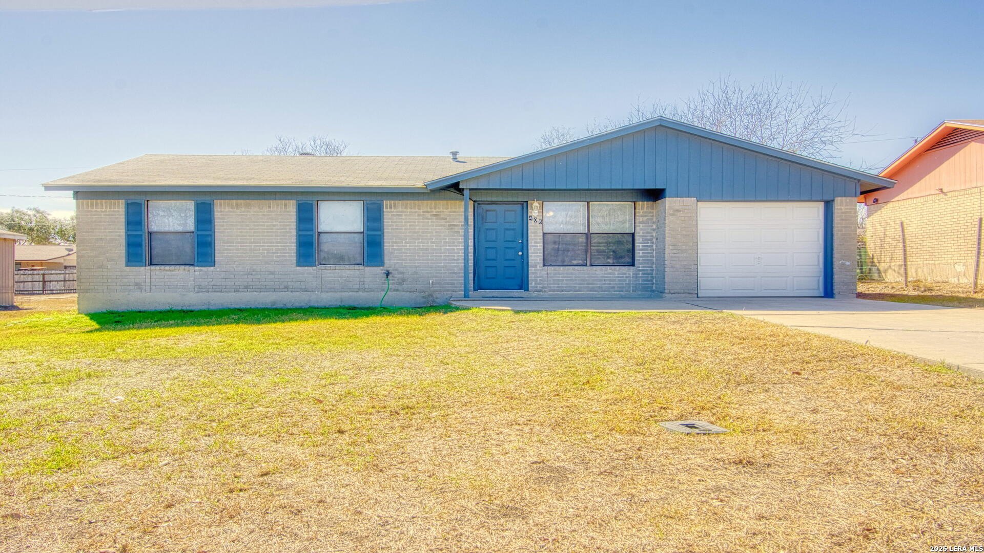 406 Pine Street Kenedy, TX 78119 - Photo 1 of 31 a front view of a house with a yard and swimming pool