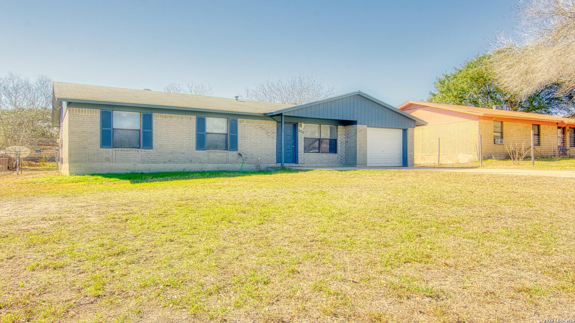 406 Pine Street Kenedy, TX 78119 - Photo 13 of 31 a view of a house with a yard