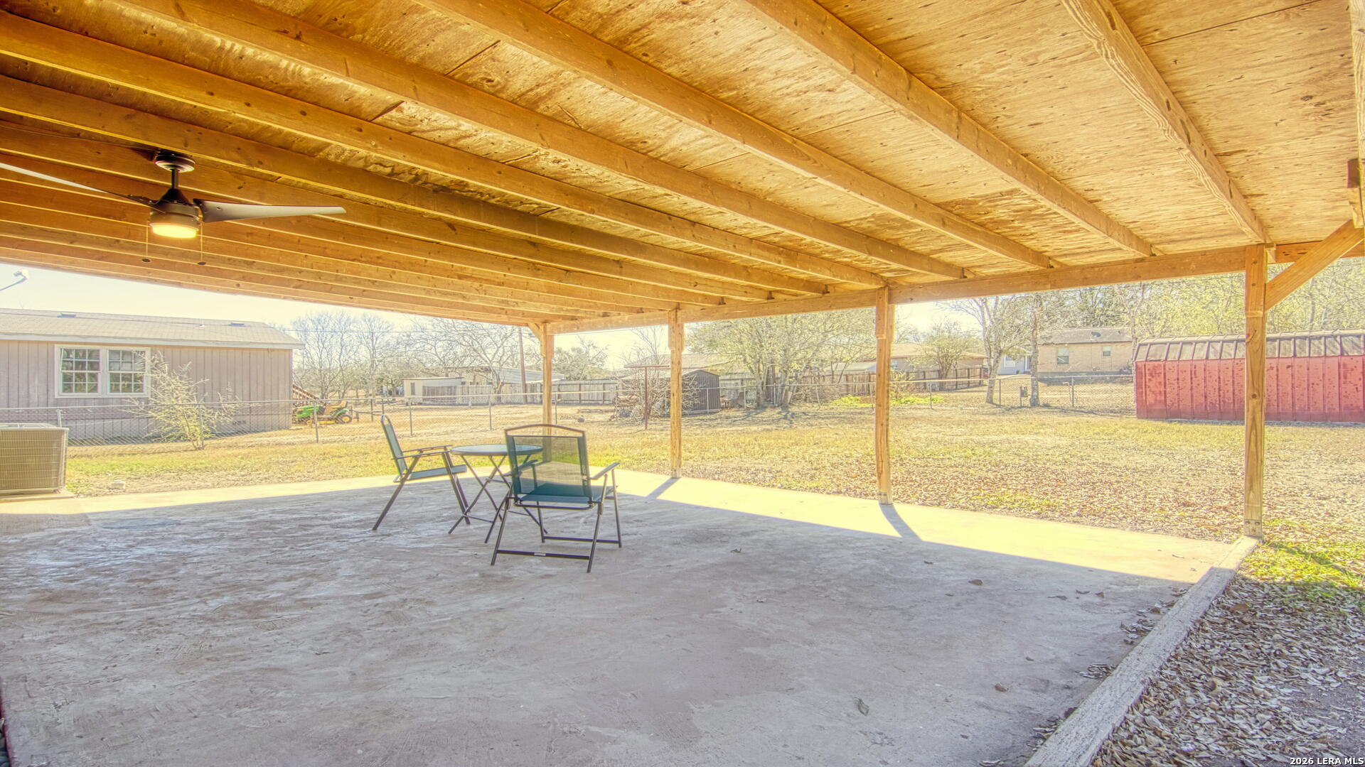 406 Pine Street Kenedy, TX 78119 - Photo 16 of 31 a view of a swimming pool with a lawn chairs under an umbrella