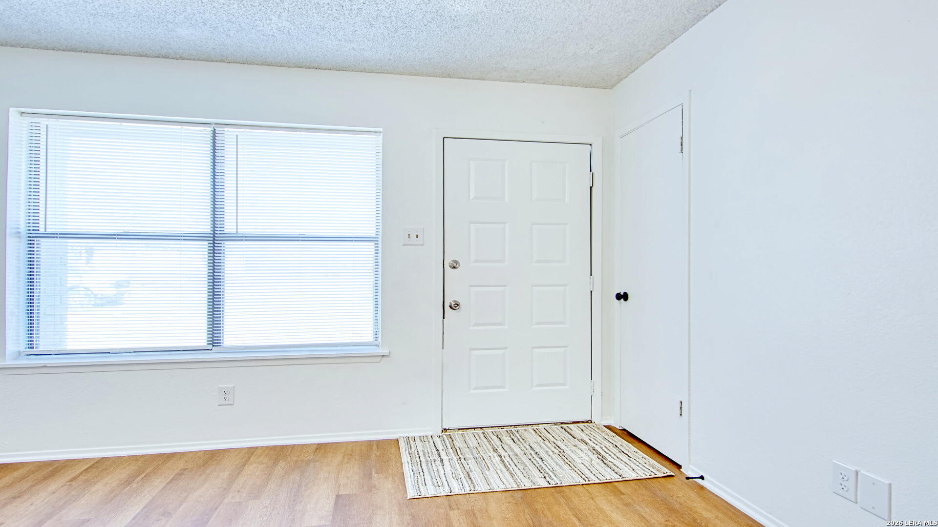 406 Pine Street Kenedy, TX 78119 - Photo 19 of 31 a view of a room with wooden floor and a window