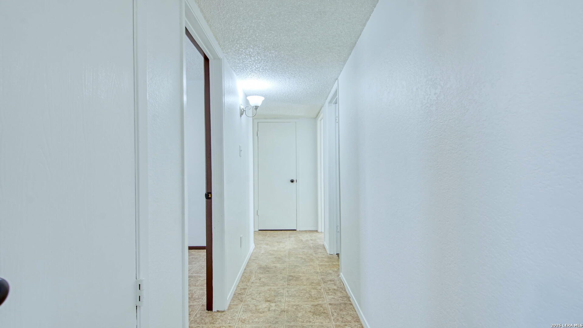 406 Pine Street Kenedy, TX 78119 - Photo 25 of 31 a view of a hallway with wooden floor