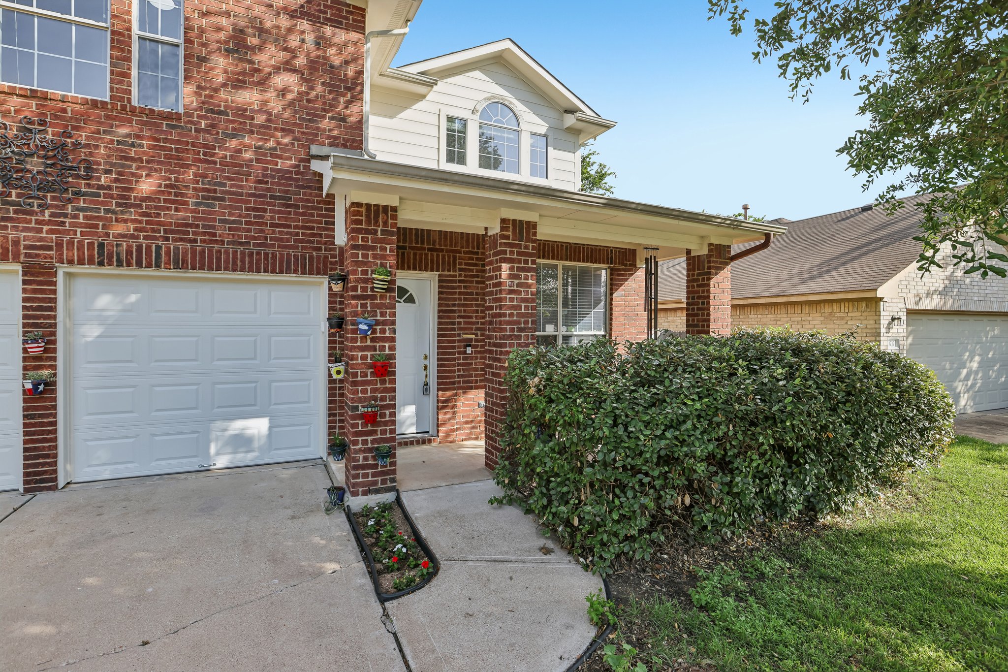 1721 Long Rifle Drive Austin, TX 78754 - Photo 4 of 38 A classic brick exterior welcomes with a covered entryway and well-maintained shrubbery.