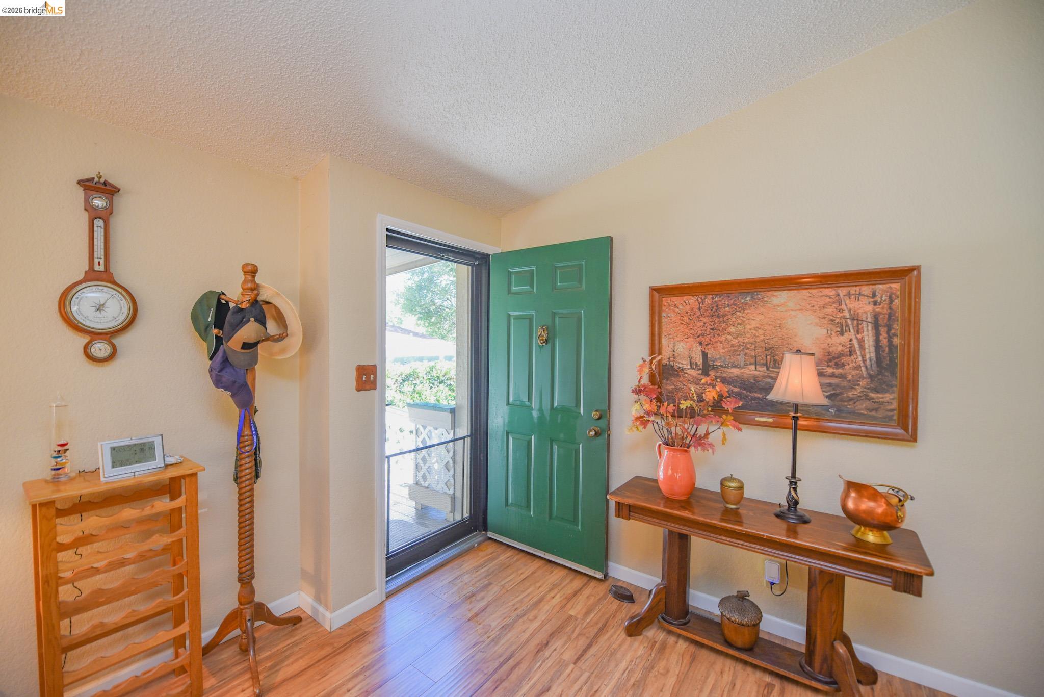 18717 Mill Villa Road, Unit 235 Jamestown, CA 95327 - Photo 7 of 26 Entrance foyer featuring light wood-type flooring and a textured ceiling
