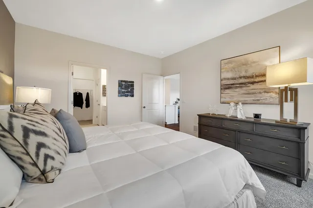 a bedroom with a bed and a lamp