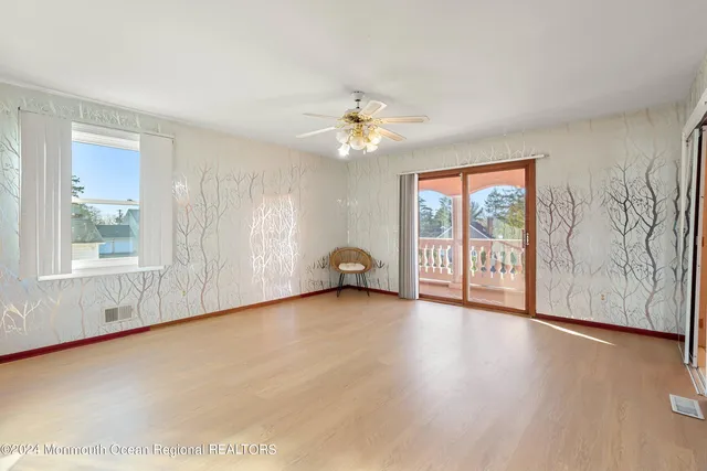 a view of livingroom with furniture wooden floor and a ceiling fan