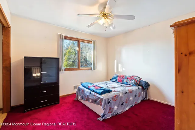 a bedroom with a bed and a dresser