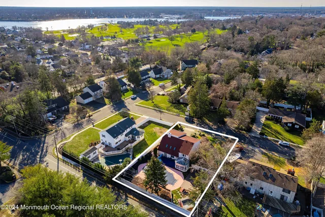 an aerial view of a house with a swimming pool