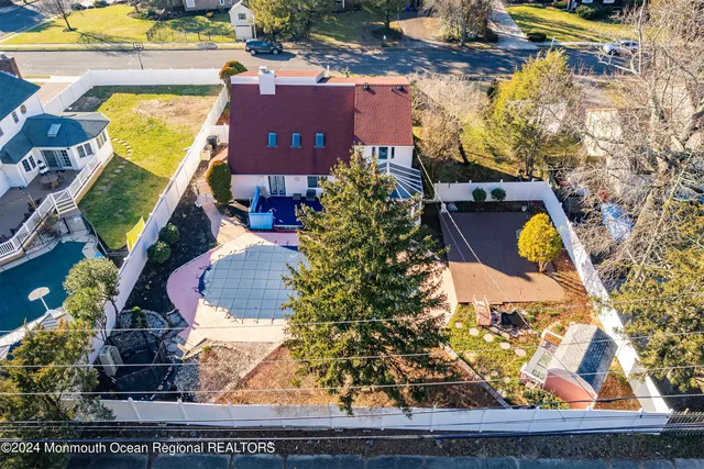 an aerial view of a house with a swimming pool