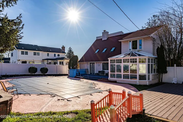 a view of a house with pool and sitting area