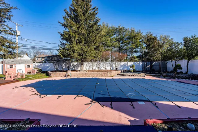 a view of a swimming pool with an outdoor space and seating area