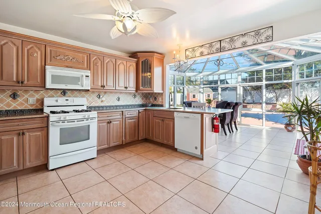 a kitchen with a stove a sink and cabinets