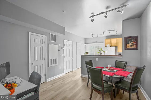 a view of a dining room with furniture and wooden floor