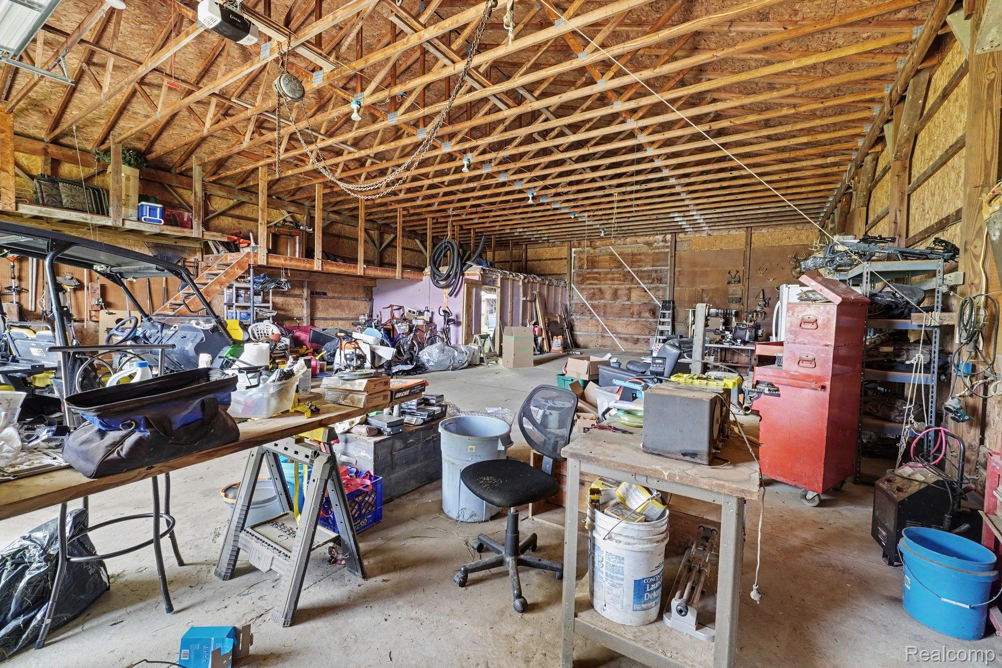 4848 Columbiaville Road Columbiaville, MI 48421 - Photo 25 of 35 Spacious utility building featuring exposed wood beam ceiling, concrete flooring, and an upper loft area