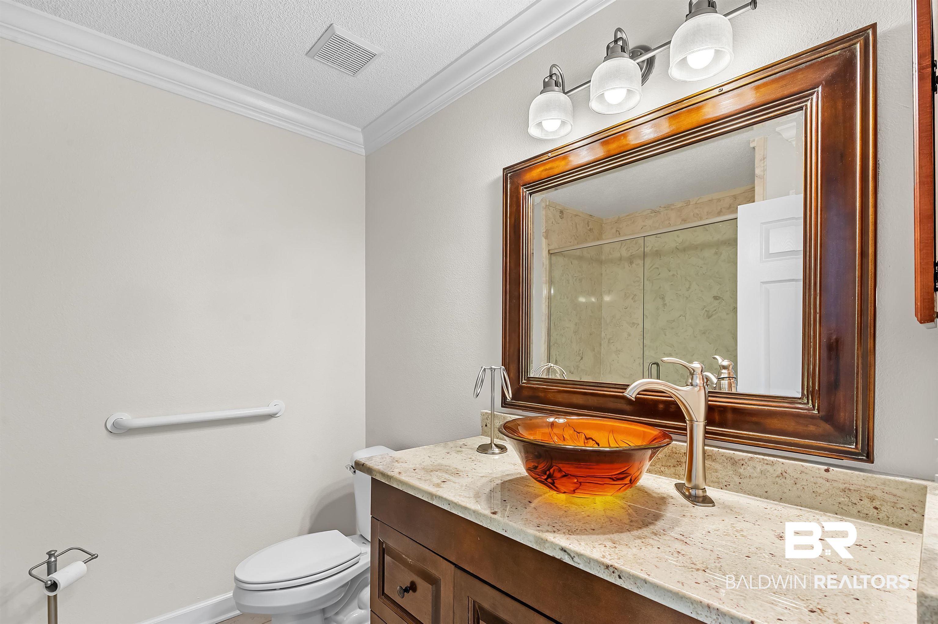 421 Collinwood Loop Foley, AL 36535 - Photo 49 of 62 Bathroom featuring toilet, ornamental molding, vanity, a textured ceiling, and walk in shower