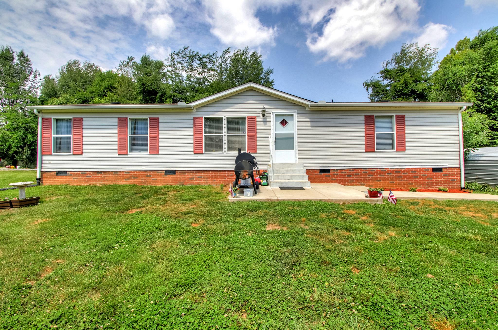 262 Dorris Road Portland, TN 37148 - Photo 1 of 29 a front view of house with yard and trees in the background