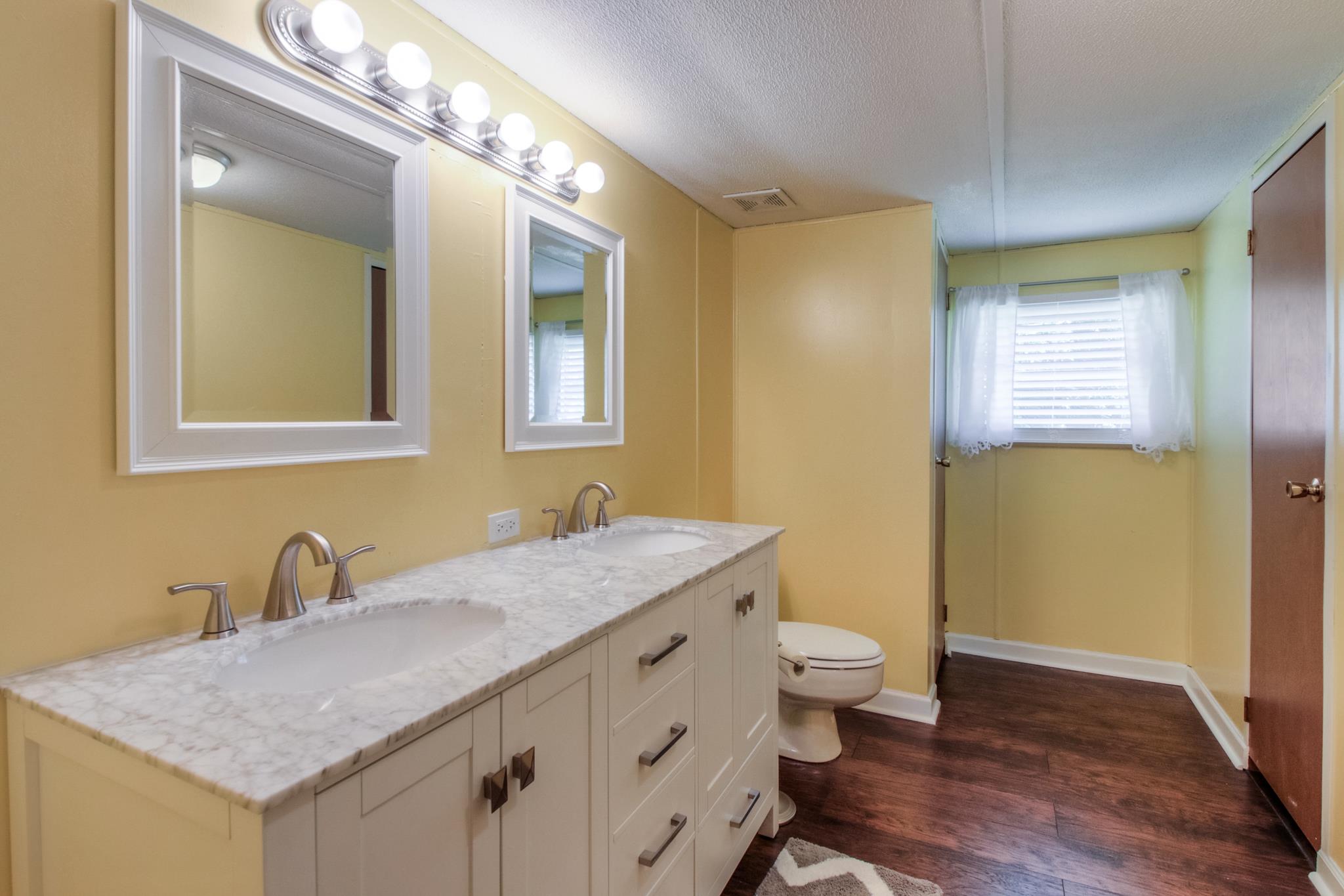 262 Dorris Road Portland, TN 37148 - Photo 5 of 29 a bathroom with a granite countertop sink a toilet and a mirror