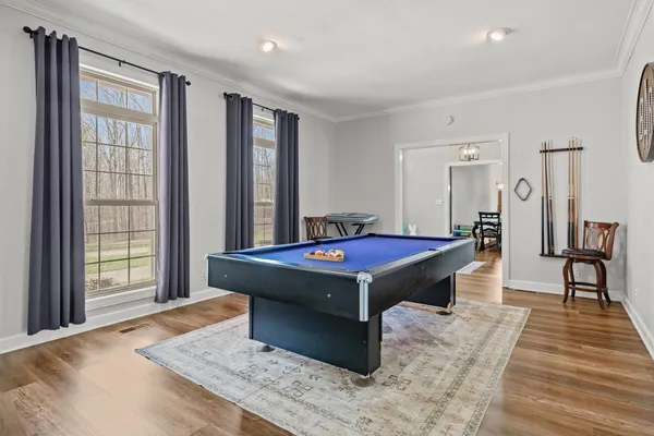 a spacious bedroom with a bed and a flat screen tv