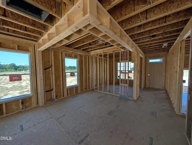 a view of an empty room with large windows
