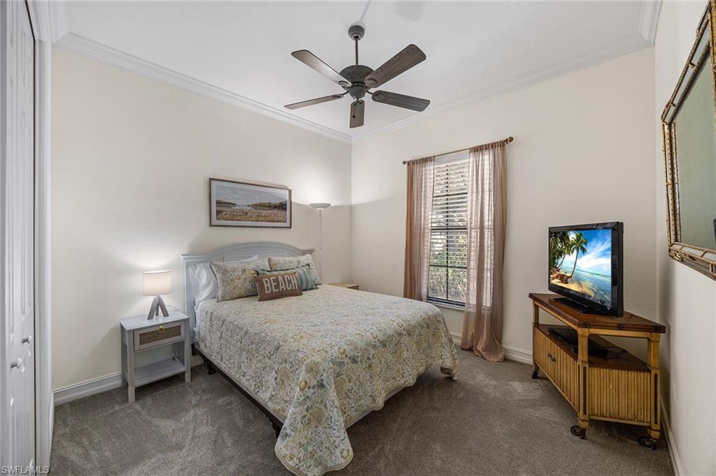 146 Windward Cay Naples, FL 34114 - Photo 19 of 33 a bedroom with a bed and a tv on the dresser