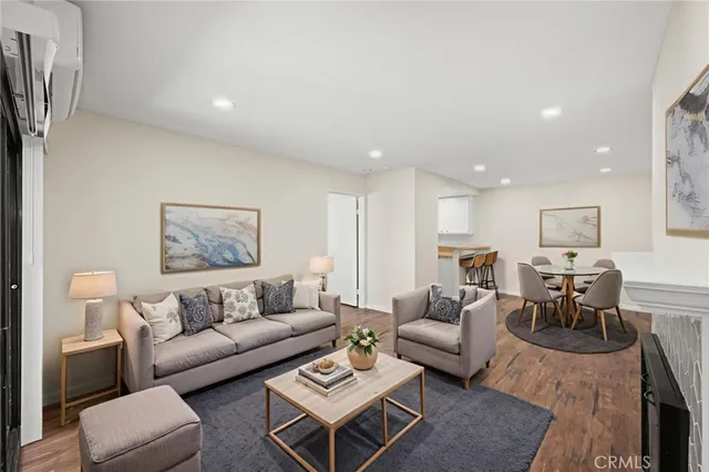 a living room with furniture a rug and a painting