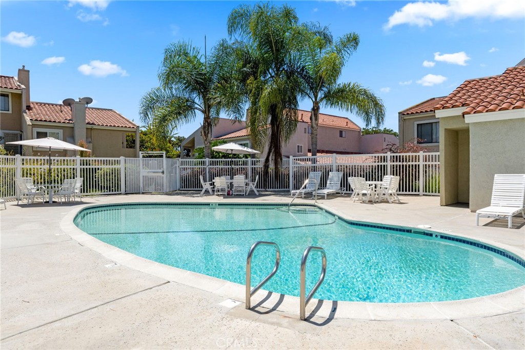 6911 Quail Place, Unit C Carlsbad, CA 92009 - Photo 15 of 18 a view of a swimming pool with a patio and plants