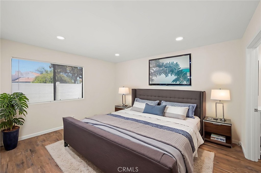 6911 Quail Place, Unit C Carlsbad, CA 92009 - Photo 7 of 18 a bedroom with bed and paintings on the wall
