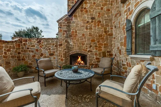 a outdoor living space with furniture and a fireplace