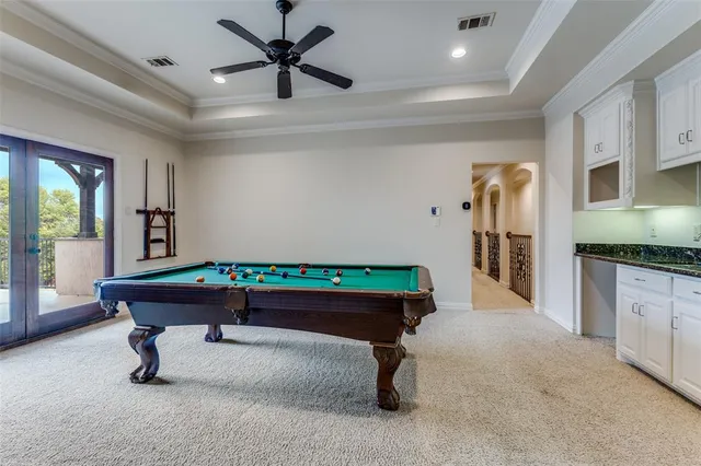 a room with pool table and windows