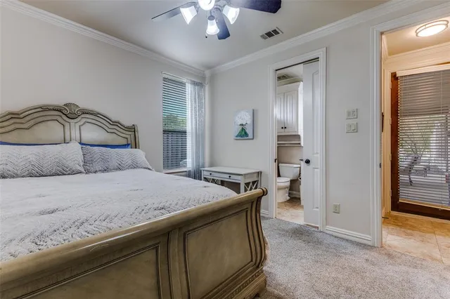 a bedroom with a bed a lamp and a window