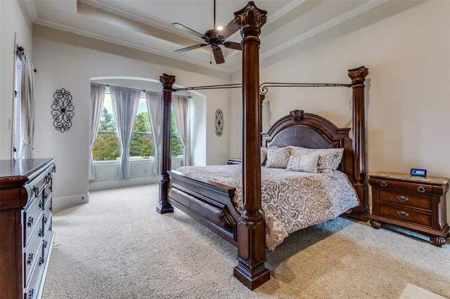 a bed room with a bed and a ceiling fan
