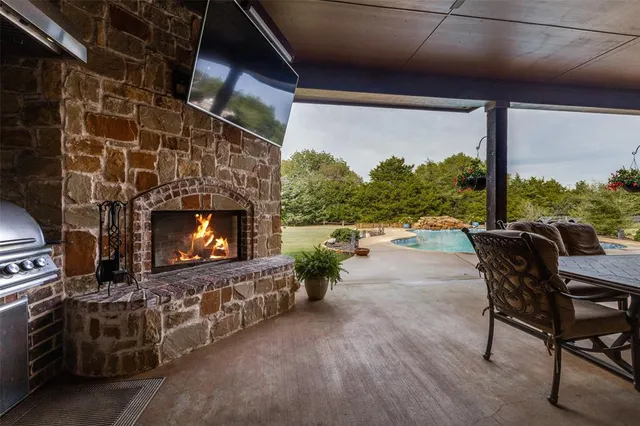 a dining area with furniture and a floor to ceiling window