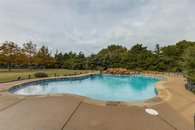 an aerial view of a house with a yard basket ball court and outdoor seating
