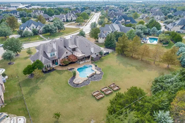 an aerial view of a house with yard swimming pool and lake view