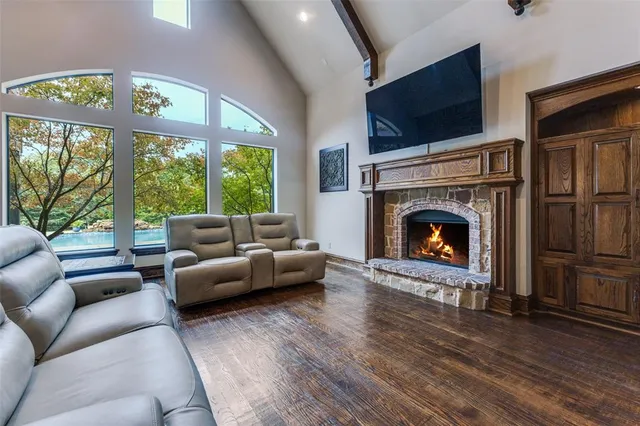a living room with furniture a flat screen tv and a fireplace