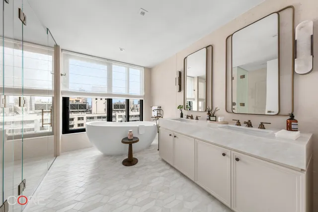 a large white kitchen with a large window and sink