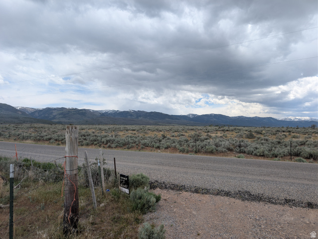 11799 Cove Creek Road Mount Pleasant, UT 84647 - Photo 13 of 15 Expansive land parcel featuring a paved road frontage, natural sagebrush landscaping, and distant snow-capped mountain ranges