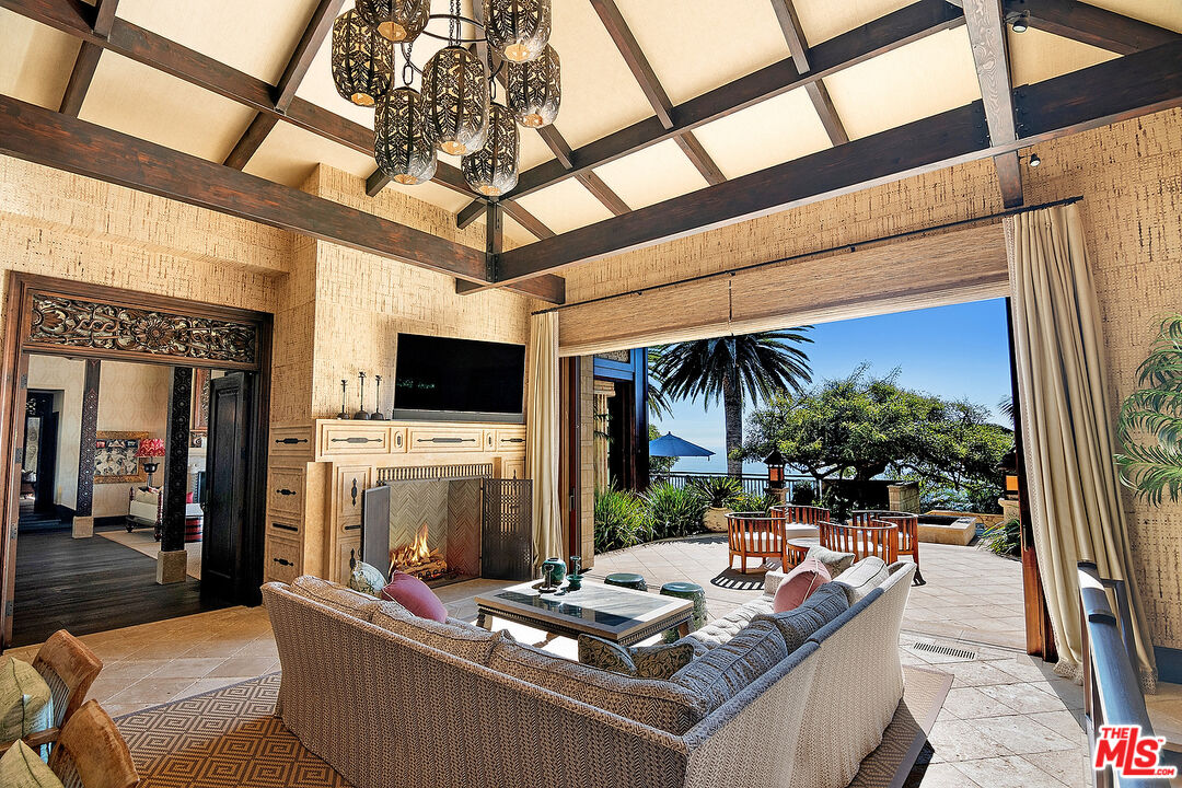 24834 Pacific Coast Highway Malibu, CA 90265 - Photo 15 of 38 a living room with furniture and a flat screen tv