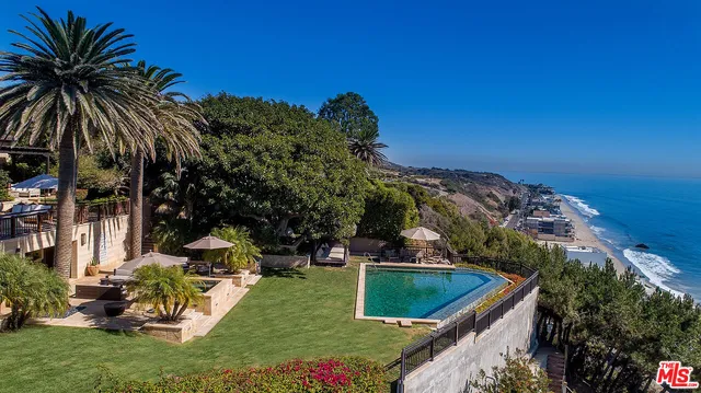 swimming pool view with a seating space