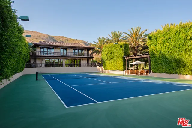 a living room with a large window and furniture