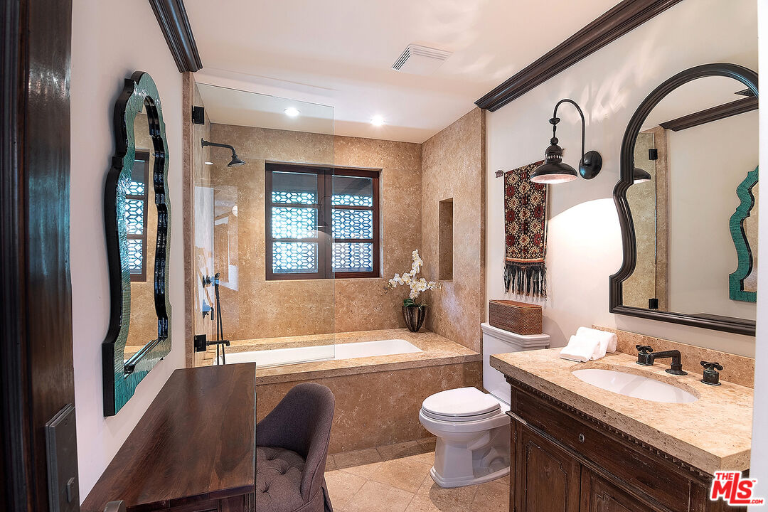 24834 Pacific Coast Highway Malibu, CA 90265 - Photo 34 of 38 a bathroom with a granite countertop sink and a mirror