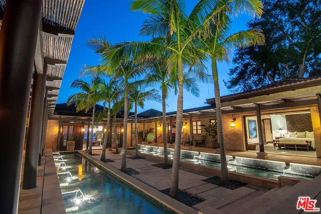 a view of a swimming pool with a table and chairs