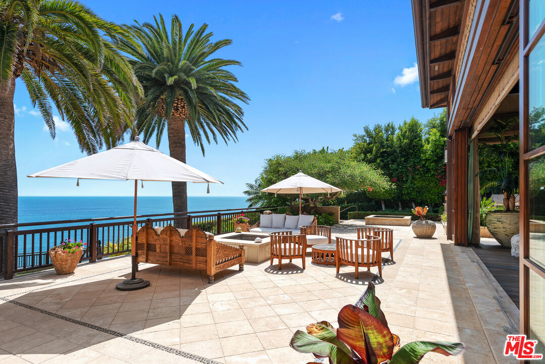 24834 Pacific Coast Highway Malibu, CA 90265 - Photo 9 of 38 a view of a swimming pool with chairs in patio