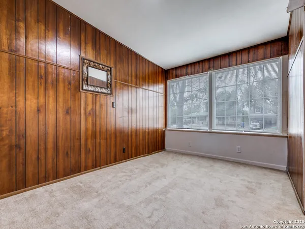 a spacious bathroom with a granite countertop sink a toilet a mirror and shower