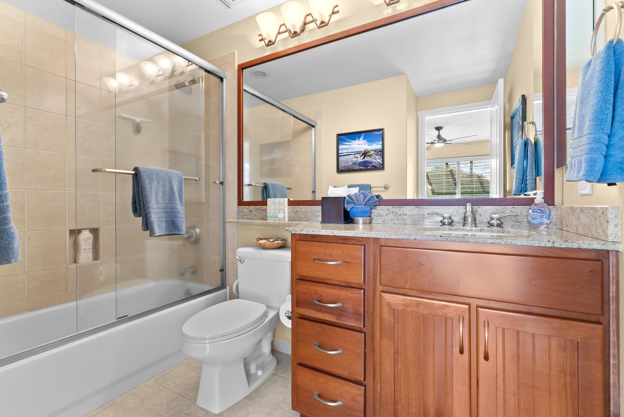 68-1122 Na Ala Hele Road, Unit Q4 Kamuela, HI 96743 - Photo 18 of 30 a bathroom with a granite countertop sink toilet a large mirror a bathtub and shower