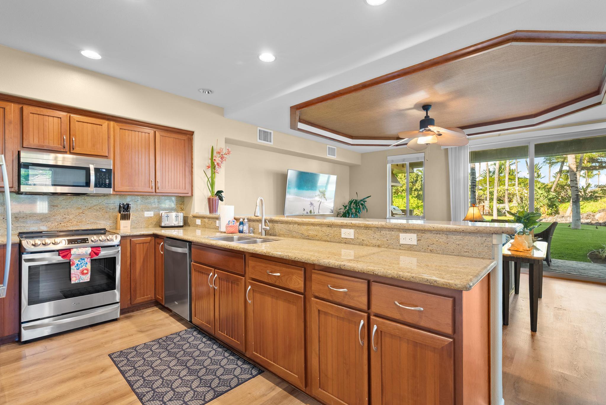 68-1122 Na Ala Hele Road, Unit Q4 Kamuela, HI 96743 - Photo 9 of 30 a kitchen with stainless steel appliances granite countertop a stove and a sink